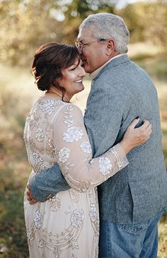 an older man and woman embracing each other