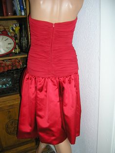 "Vintage 70s, red silk and satin strapless formal cocktail dress. By Morton Myles for the Warrens, Saks Fifth Avenue. Back zip. Large side bow, ruched top, dropped waist. Sides of bodice are boned. Red union label. Lined. Excellent condition, no flaws or damage. Measurements: chest across front: 16\" waist (natural) across front: 12\" hips across front: 16\" length: (from armpit) 34\" plus 1\" hem Please read all measurements and view all photos provided before purchasing as I do NOT accept retu Silk Strapless Dress With Ruched Bodice For Cocktail, Red Satin Strapless Dress For Prom, Silk Strapless Dress With Ruched Bodice For Party, Red Fitted Satin Strapless Dress, Red Satin Strapless Fitted Dress, Formal Silk Strapless Dress For Prom Season, Silk Strapless Dress For Prom Season, Red Strapless Satin Evening Dress, Red Strapless Dress With Ruched Bodice For Cocktail