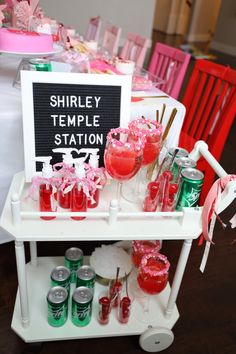 there is a table with drinks on it and a sign that says shriley temple station