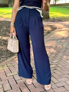 Navy blue wide leg trouser pant High rise waist with elastic at sides Front pleats Side pockets 12.5" rise 30" inseam Wide leg silhouette 52% Recycled Polyester, 48% Polyester Hand wash cold Elina (model) wears a small Ember wears a large Model measurements: Height: 5’4”, Bust: 34”, Waist: 26”, Hips: 39” Color may vary due to lighting on image Solid Color Pleated Wide Leg Pants, Solid Pleated Wide Leg Pants, Casual High Waist Pleated Wide Leg Pants, Solid Color Pleated Wide-leg Pants, Pleated Wide-leg Pants, Wide Leg Dress Pants With Welt Pockets, Business Casual Wide Leg Pants With Pressed Crease, Wide Leg Bottoms With Pressed Crease For Fall, Casual Fitted Waist Pleated Wide Leg Pants