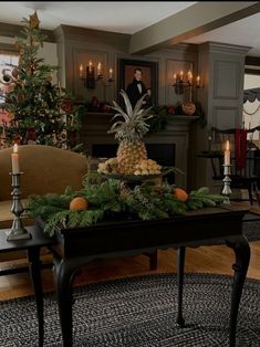 a living room decorated for christmas with pineapples and oranges on the coffee table