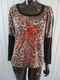 Retro T-shirt black/leopard print with a red design on the front. Size S. Made by Suzanna Paris from a cotton mix. Dimensions: Bust: 36 Inches. Length: 23 Inches. Sleeve: 15 Inches. Black Tiger Print Crew Neck Top, Black Crew Neck Top With Tiger Print, Casual Stretch Tiger Print Tops, Leopard Print Graphic T-shirt For Summer, Summer Leopard Print Graphic T-shirt, Black Tiger Print Long Sleeve Tops, Black Long Sleeve Top With Tiger Print, Black Long Sleeve Tiger Print Tops, Fitted Black Top With Tiger Print