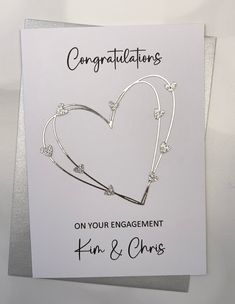 an congratulations card with a heart on the front and two hearts on the back, attached to a white envelope