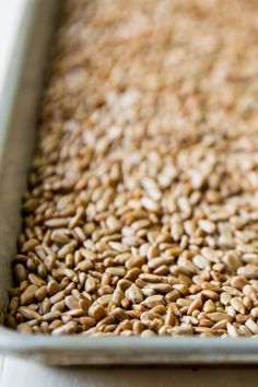 a pan filled with brown rice on top of a table