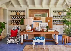 a living room filled with furniture and lots of plants on top of it's shelves