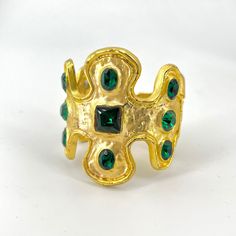 "Stunning Kenneth Lane cuff bracelet features faceted Emerald tone crystals set in satin gold with a light patina finish. The Emerald Green jewels are set in broad raised incrustations inspired by the Yakmur bracelet in the Louvre. Signed KJL for Kenneth Jay Lane. 2\" opening front to back Measures 2-5/8\" across.  Once hinge is pulled back opening is 1&1/2inch 2&1/2\" at tallest Well constructed with good heavy weight in Excellent condition." Vintage Jeweled Gold Cuff Bracelet, Gold Cuff Bracelet With Jewels As Gift, Gold Jeweled Cuff Bracelet, Gold Jeweled Cuff Bracelet As Gift, Gold Jeweled Cuff Bracelet Bangle, Gold Jeweled Cuff Bracelet Perfect As A Gift, Gold Jeweled Cuff Bracelet For Gift, Gold Jeweled Cuff Bracelet For Gifting, Elegant Green Metal Cuff Bracelet