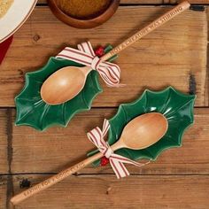 two wooden spoons with christmas decorations on them