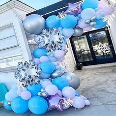 the balloon arch is decorated with blue and silver balloons