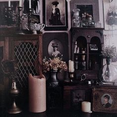 there are many pictures and vases on the wall