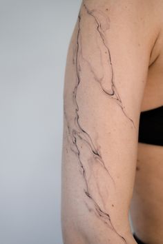 a woman with a tattoo on her arm