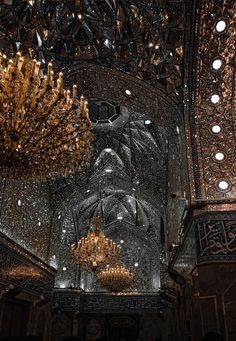 the chandelier is hanging from the ceiling in an ornate building with many lights