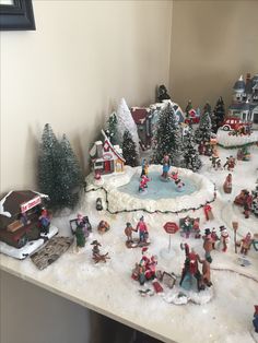 a christmas scene with toys and people in the snow