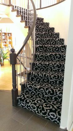 a staircase with black and white carpet on it