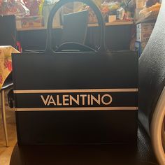 You Can't Go Wrong With The Meline Tote From Valentino By Mario Valentino. This Leather Handbag Features An Embossed Logo Accent And Removable Crossbody Strap For Carrying Versatility. Leather Color: Black Top Snap Closure Top Handles With 6" Drop Removable Shoulder Strap With 17" Max. Drop Interior Pockets: 1 Pen Holder, 1 Zip, 3 Slip Leather Lining 12" L X 6" W X 9" H Made In Italy New, Not Used With Duster Bag And Card Included. Designer Logo Bags For Shopping, Leather Bags With Designer Logo For Shopping, Designer Logo Leather Bags For Shopping, Designer Logo Leather Shopping Bags, Black Designer Logo Bag For Everyday Use, Black Designer Logo Bag For Everyday, Black Rectangular Bag With Designer Logo, Elegant Shopping Bag With Designer Logo, Black Rectangular Designer Logo Bag