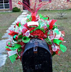 a mailbox decorated with red, green and white decorations