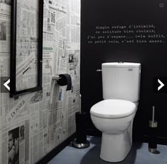 a white toilet sitting inside of a bathroom next to a wall covered in news paper