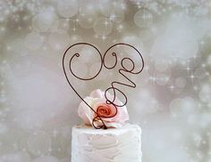 a wedding cake with the number twenty nine on top and a rose in the middle