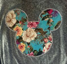 a mickey mouse shirt with flowers on it