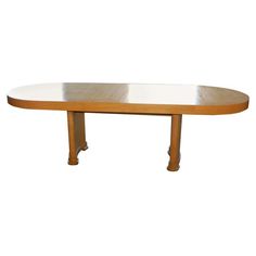 an oval wooden table with white top