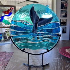 a blue glass plate sitting on top of a metal stand