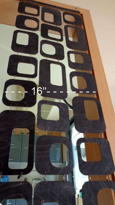 the mirror is made out of wood and has many different shapes on it's sides