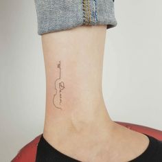 a small tattoo on the ankle of a woman's lower back neck and foot