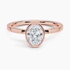 a rose gold ring with a oval cut diamond