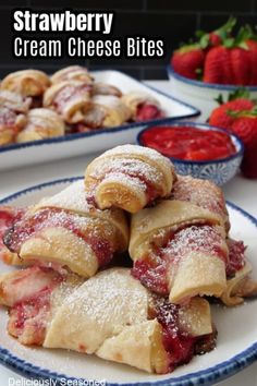 strawberry cream cheese bites on a plate with strawberries