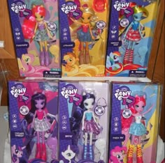 there are four little pony dolls in the box set, and one is wearing a dress with sequins on it