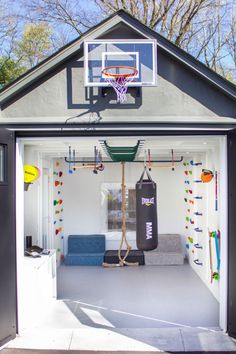 the inside of a small house with a basketball hoop and gym equipment on it's wall