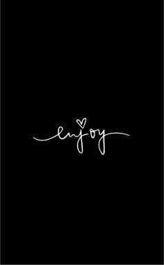 the word enjoy written in cursive writing on a black background with white ink