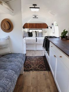 the interior of a tiny home with white walls and wood flooring, including a couch