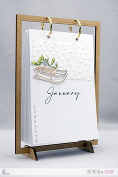 a card with a notepad attached to it that says january on the front and side