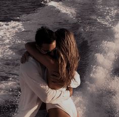 two people embracing each other on a boat