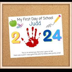 a bulletin board with a handprinted sign on it that says, my first day of school judd