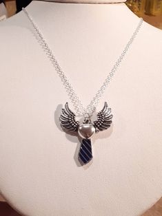 Castiel of Supernatural inspired tie and angel wing pendant necklace. This silver necklace is 18 inches in length, 1.2mm in thickness. *Tie options of new outfit solid dark blue or striped blue w/light blue from previous seasons* Angel Wing Pendant, Castiel, Blue Stripes, Pendant Necklaces, New Outfits, Supernatural, Jewelry Necklace Pendant, Dark Blue, Silver Necklace