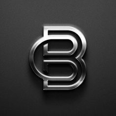 the letter b is made up of metal and has been placed on a black surface