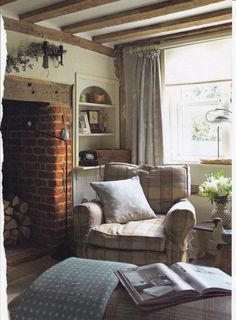 a living room filled with furniture and a fire place in front of a brick fireplace