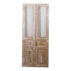 an old wooden double door with glass panels