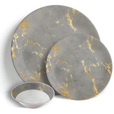 three gray and gold marble plates next to each other