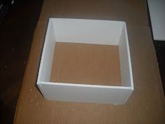 an empty white box sitting on top of a wooden table