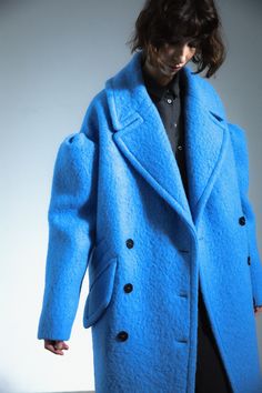 Drop-shoulder coat, virgin wool, sky blue. Crafted in soft alpaca and luxe virgin wool, this sky blue statement coat epitomizes femininity imbued with playfulness. Accented by pleated dropped-shoulders, it creates a fierce, unexpected silhouette.