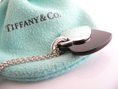 Offered for sale is a wonderful Tiffany classic. Whether you are just starting your Tiffany collection or are thinking of adding another piece, this one is perfect for you. Tiffany & Co.'s Sterling Silver & Onyx Double Heart necklace is a Tiffany classic that will never go out of style. It will most certainly be a piece that you will turn to over and over again, so it is great value for your money! It is a wonderful necklace that fits a lifestyle on the go -- the necklace can be worn to Designer Black Necklace As A Gift, Designer Black Necklace For Gift, Designer Black Necklaces For Gift, Luxury Black Heart Pendant Jewelry, Luxury Black Heart Pendant Necklace, Double Heart Necklace, Gift Love, Double Heart, Two Hearts