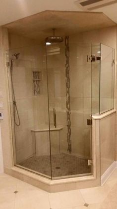 a walk in shower sitting inside of a bathroom