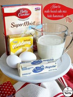 eggs, milk, butter and flour on a cake plate with napkins next to it