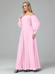 a woman wearing a pink dress with long sleeves and an off the shoulder neckline