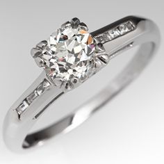 This classic vintage engagement ring is centered with a round old European cut diamond, weighing 0.66 carats, in a four split prong setting. The shoulders are each channel set with three (3) baguette cut diamonds. The ring measures 5.5mm at the top, rises 6.1mm above the finger, tapering to 1.4mm wide and 1.0mm thick at the base of the shank. The ring is currently a size 5.5 and we offer complimentary resizing to fit. Classic Style Ring With Single Cut Diamonds, Classic Cushion Cut Diamond Ring With Single Cut Diamonds, Classic Platinum Diamond Ring Channel Set, Classic Platinum Diamond Ring With Channel Set, Vintage Channel Set Diamond Ring For Anniversary, Classic Diamond Ring With Channel Set, Classic Diamond Ring With Channel Set Round Cut, Classic Diamond Ring With Channel Set Baguette Cut, Classic Round Cut Single Diamond Ring