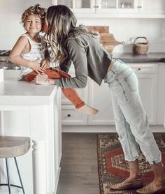 a mother and her child are in the kitchen