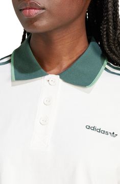 Add a sporty element to your street style with this cropped cotton polo featuring logo embroidery and 3-Stripes detailing on the sleeves. Button half placket Spread collar Short sleeves 100% cotton Machine wash, dry flat Imported Sporty Collared Polo Shirt With Three Stripes, Sporty Collared Polo Shirt For Streetwear, Spring Sports Cotton Polo Shirt, Casual Polo Shirt With Three Stripes, White Polo Shirt With Striped Collar For Spring, Spring Cotton Polo Shirt For Sports, Casual Collared Polo Shirt With Three Stripes, Spring White Polo Shirt With Striped Collar, Sporty Polo Shirt With Striped Collar