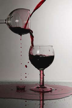 red wine being poured into two glasses